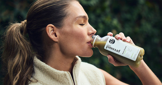 a glass of green juice
